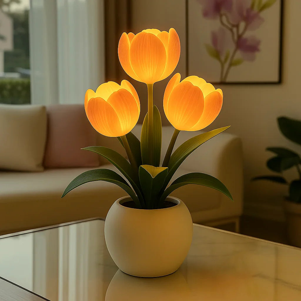 Lumiere Blossom LED decorative lamp featuring three glowing orange tulip lights in a white pot, placed on a glass coffee table in a modern living room setting.